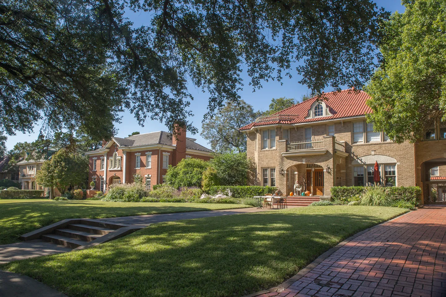 Historic homes beneath a mature tree canopy on Swiss Avenue in Dallas